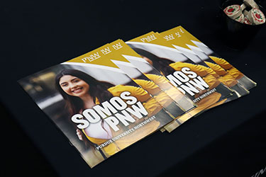A stack of "Somos PNW" brochures on a table.