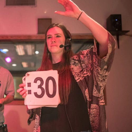 A PNW student holds up a sign that reads ":30" inside the broadcast production studio