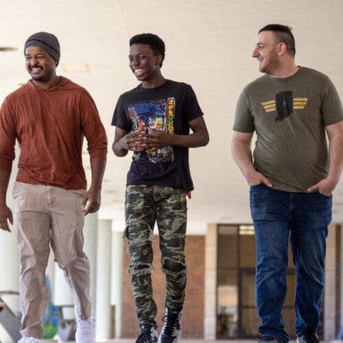 Three PNW Veteran students walk together outside the Classroom Office Building.