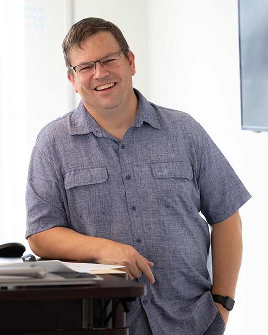 PNW professor John Durocher stands at a podium.
