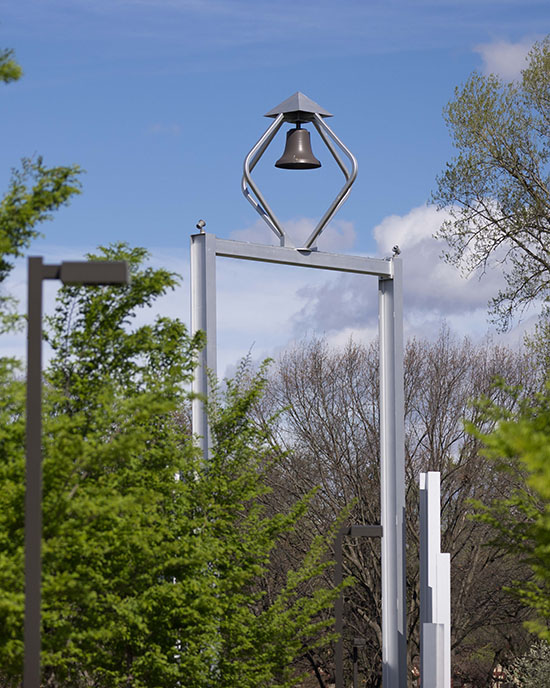 The PNW bell tower surrounded by green trees.