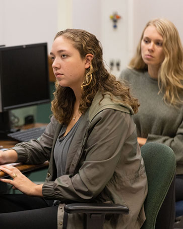 Two students sit at computers