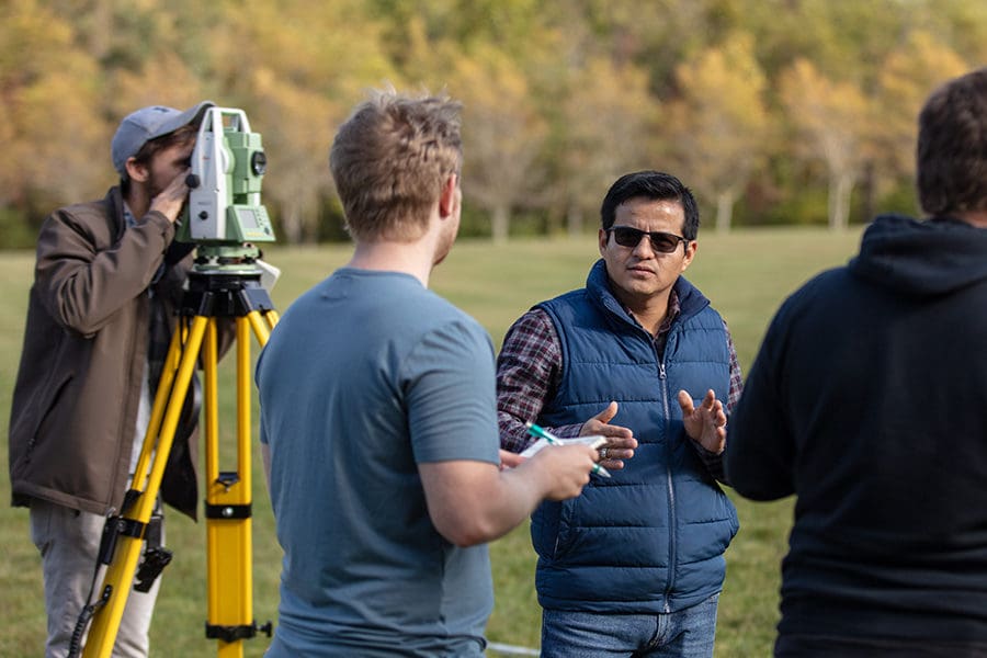 Students working with surveying equipment