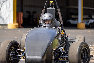 An engineering student in a race car.