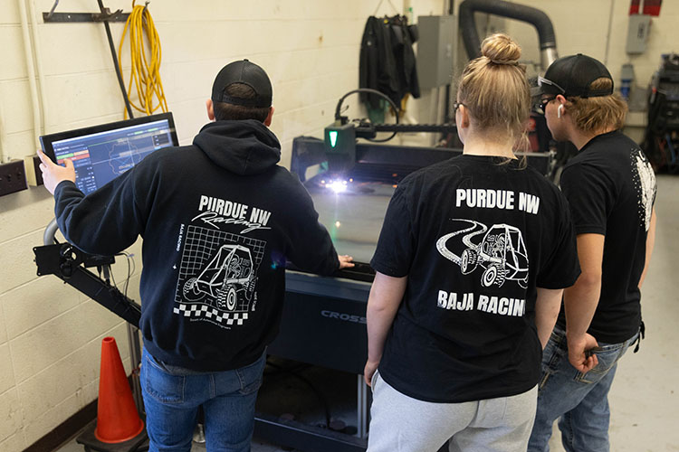 Students on the Baja motorsports team run a machine