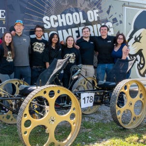 Students gather with their NASA Rover outside of the School of Engineering trailer.