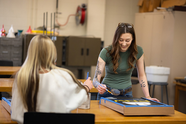 Students in the PNW Construction Club paint a project