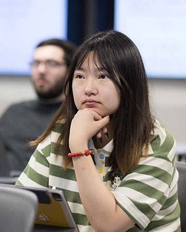 An engineering student sits in class