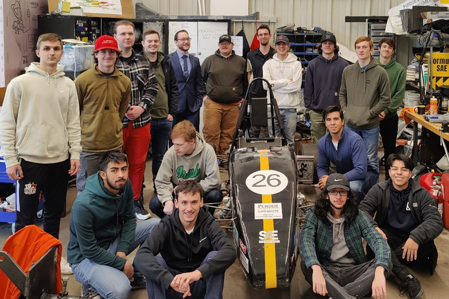 Students pose with their FSAE car
