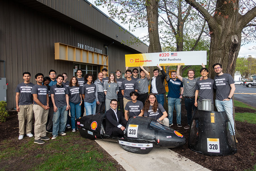 Students pose around their shell eco-car