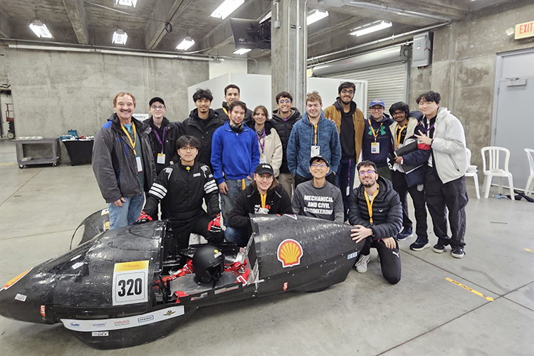 MCE Group photo with project in front of the group of people