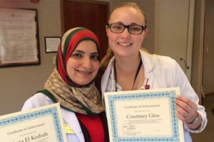 Medical students pose with their certificates of achievement