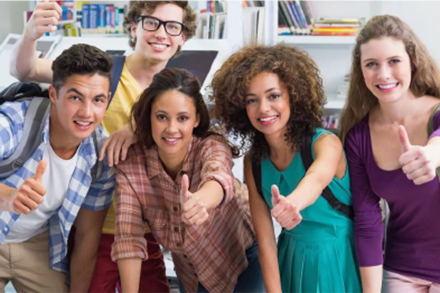 A group of students gives a thumbs up