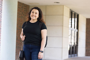 A PNW psychology student stands outdoors.