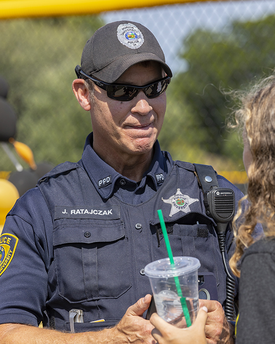 a PNW police officer talks with a student during an event