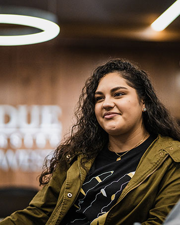 A student sits in a conference room