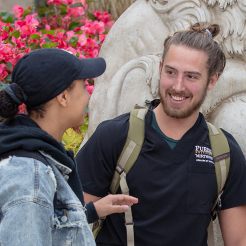 Students talk together on campus.