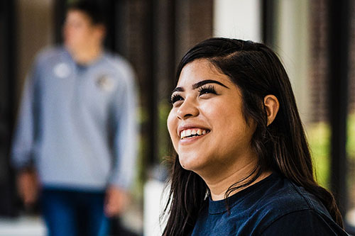 A student smiles on campus