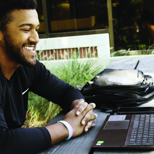 Student Sitting at Desk with laptop