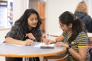 PNW students talk over a table