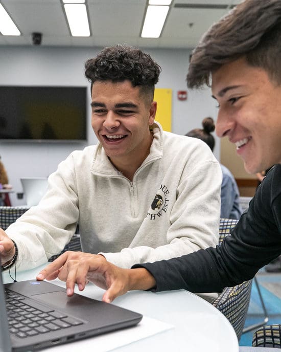 Students researching on a laptop