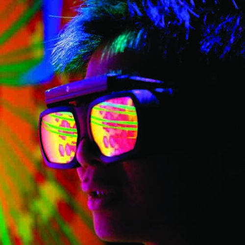 A person wearing reflective goggles looks at a blast furnace simulation