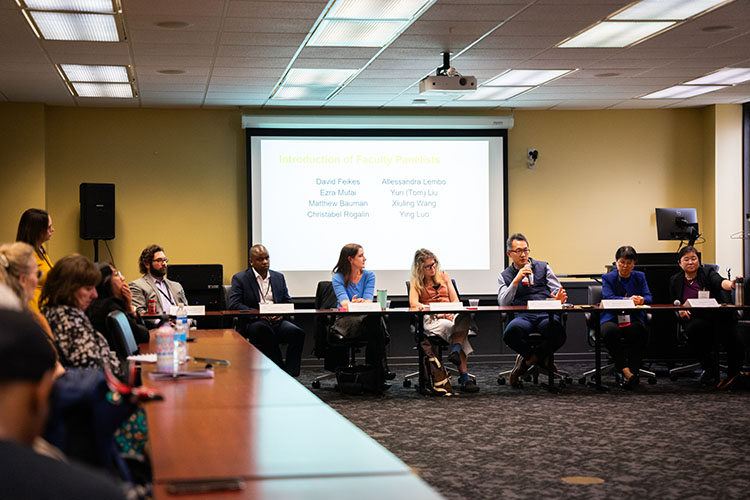 Faculty speak during a research panel