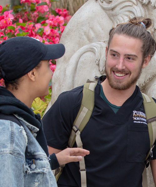 Students talk together on campus.