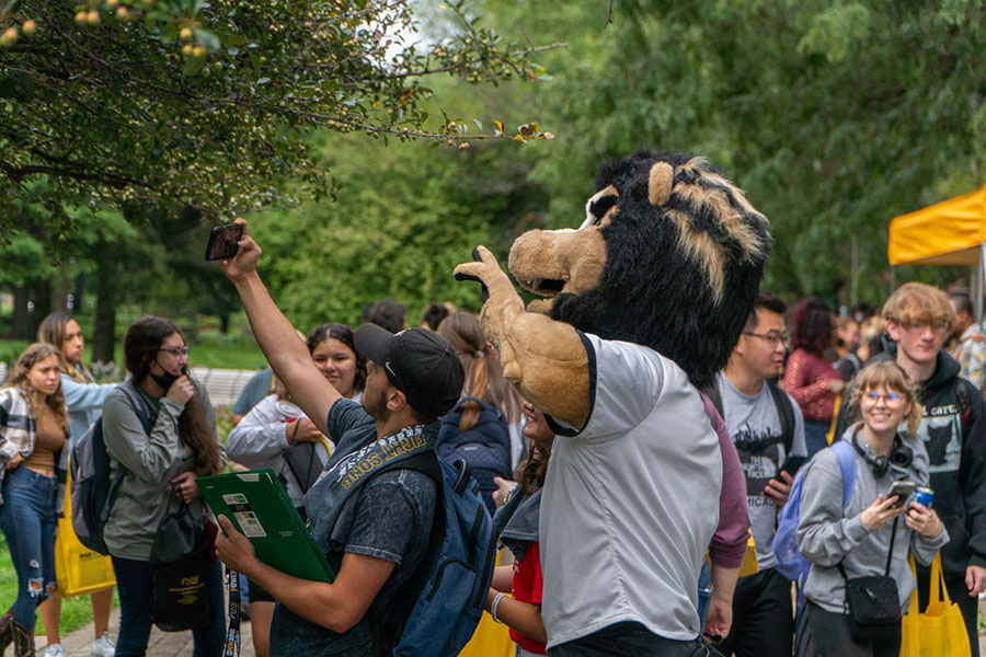 Group of people pose with PNW's Leo mascot