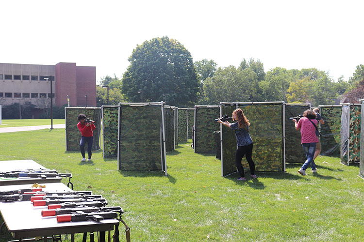 Students play combat archery in a field on PNW's Hammond Campus
