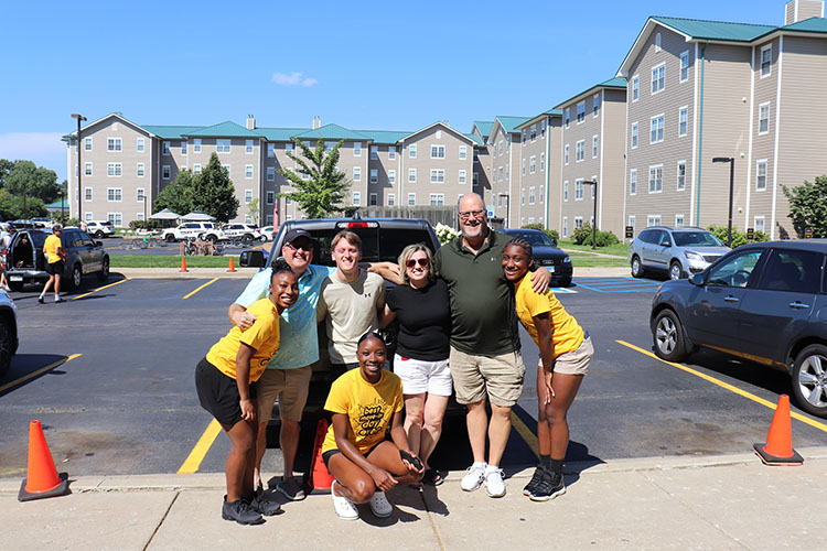 Students and families pose in a group.