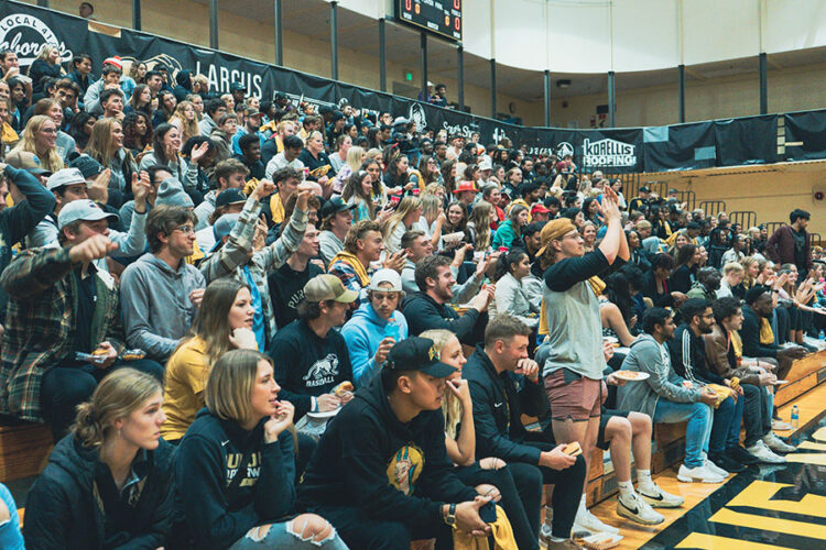 Students fill bleachers during a sporting event in the FRC gym