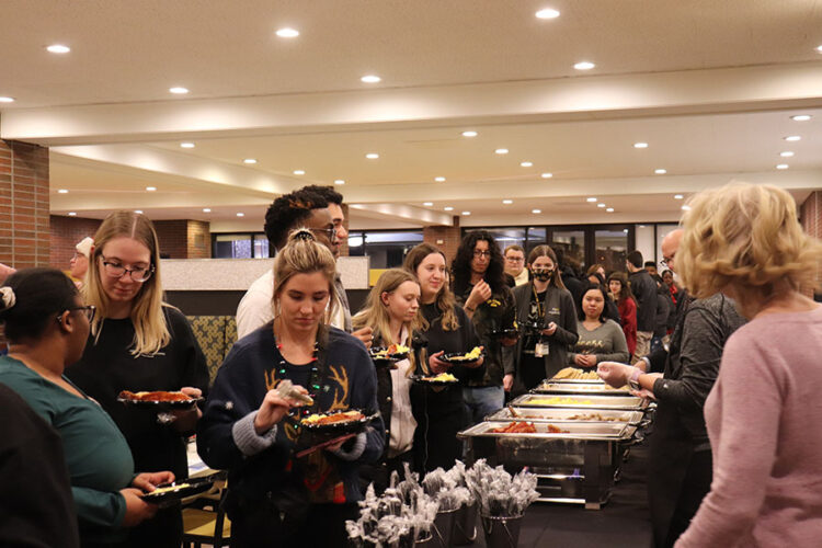 Students stand in line to receive pancakes