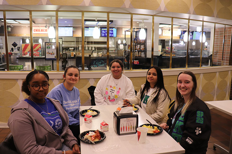 Students sit at a table in the Hammond cafe