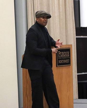Kevin Powell speaks on stage during an MLK Day event.
