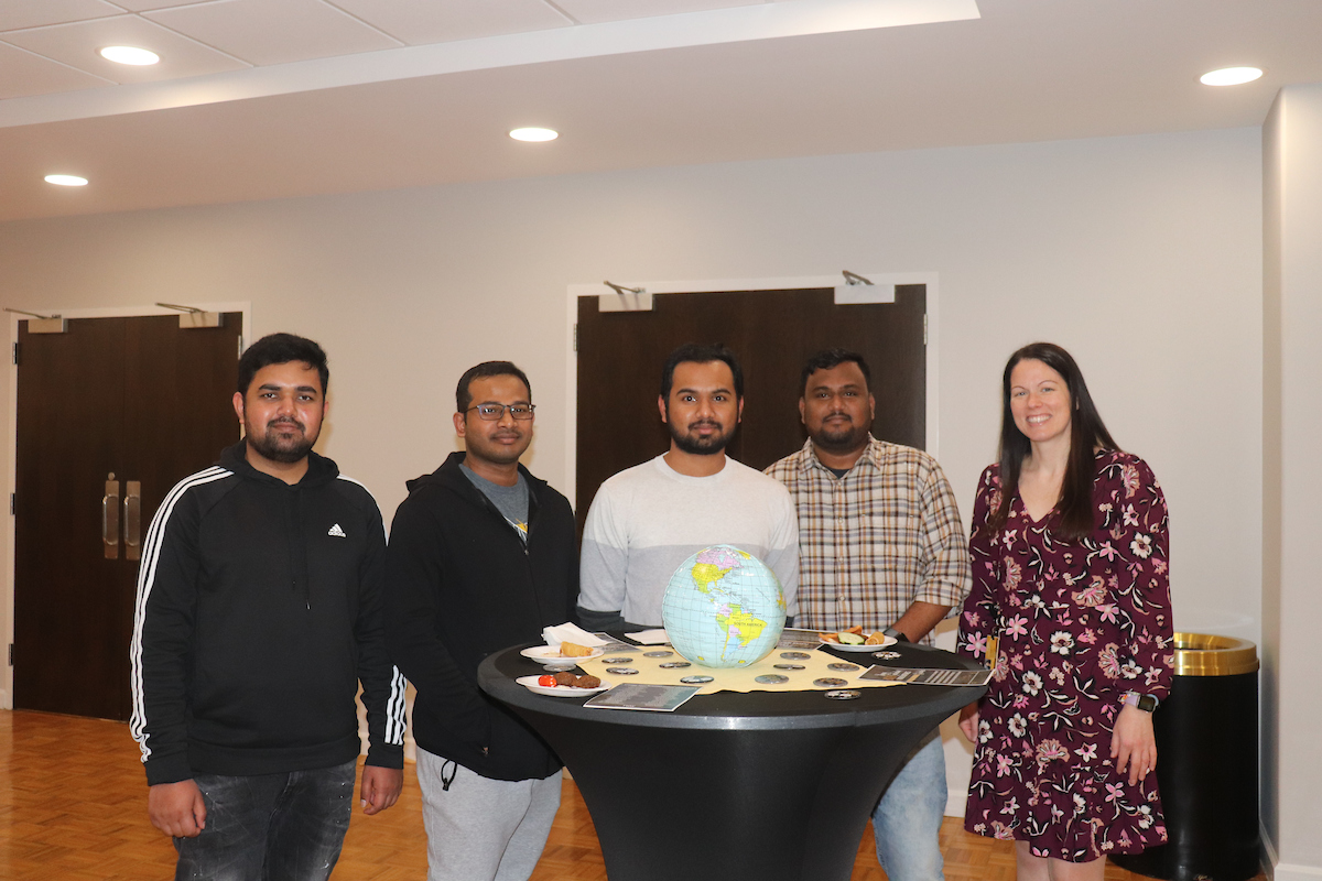 International students gather for a graduate celebration.