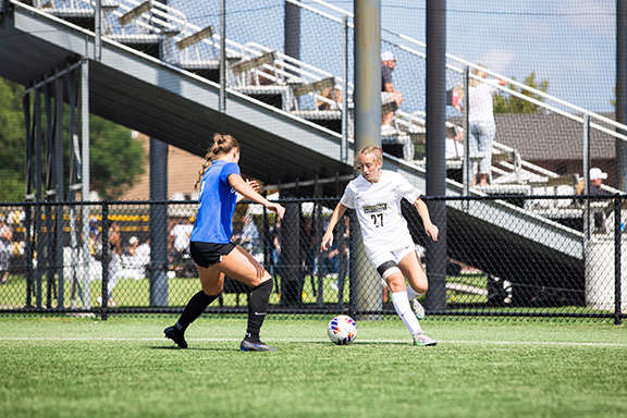 Two athletes playing soccer at the Homecoming Sports Fest
