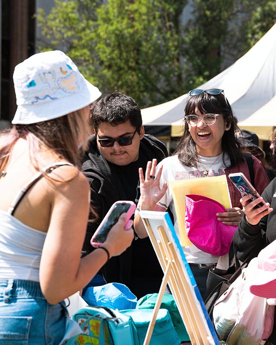 Students collect giveaways outdoors at the PNW Welcome Rally.
