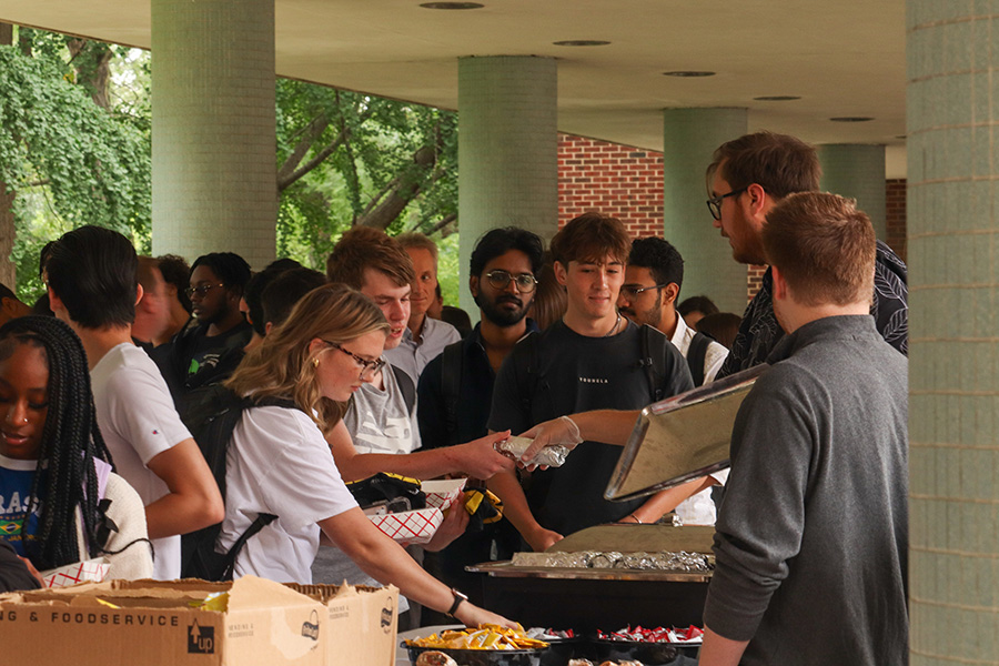 PNW CHESS Welcome Picnic, students picking up food at the table
