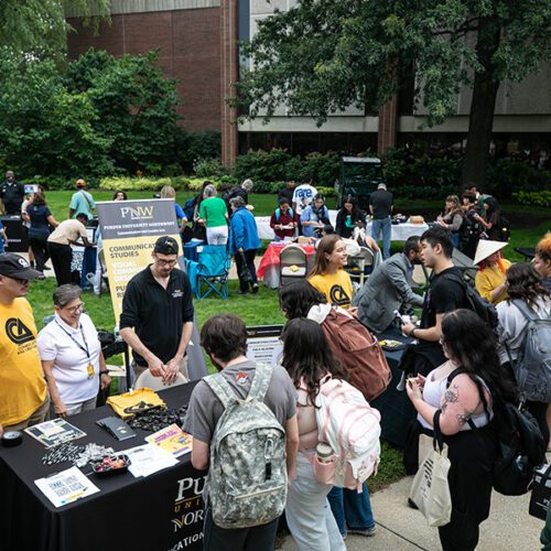 Fall 2025 Welcome Rally, students talking with the CCA department table