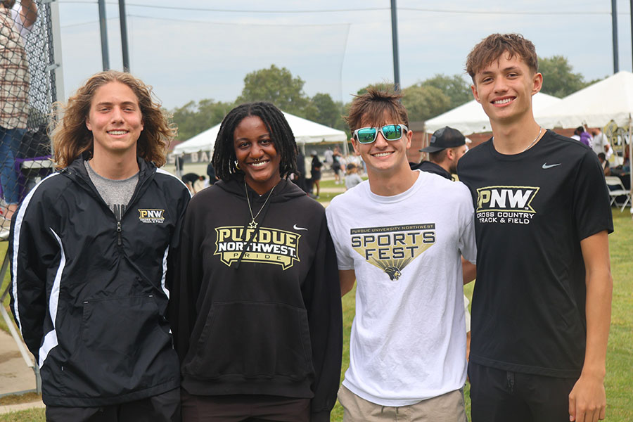 Four people pose together at Sports Fest