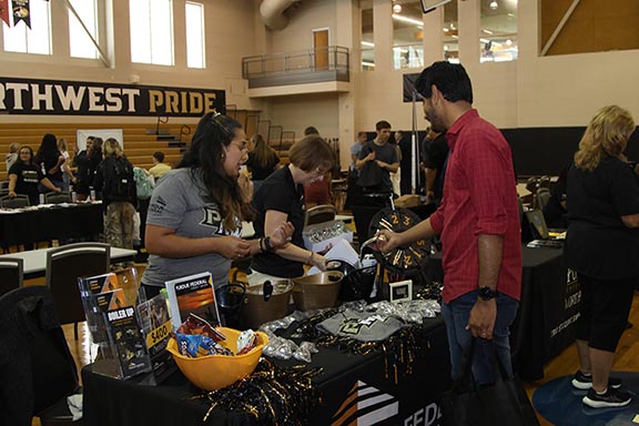 Westville Welcome Rally - students looking at organization tables 576x384