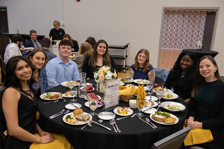 PNW students sitting at a table together at the 2026 Chancellor's Ball 750x500