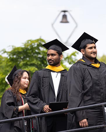 2026 PNW Graduate looking into the distance as they walk onto the stage