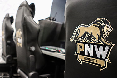 The gaming chairs in the PNW esports arena. The back of the chairs holds the esports logo.