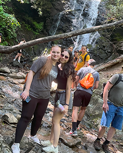 Students stand in front of a waterfall in the Smoky Mountains
