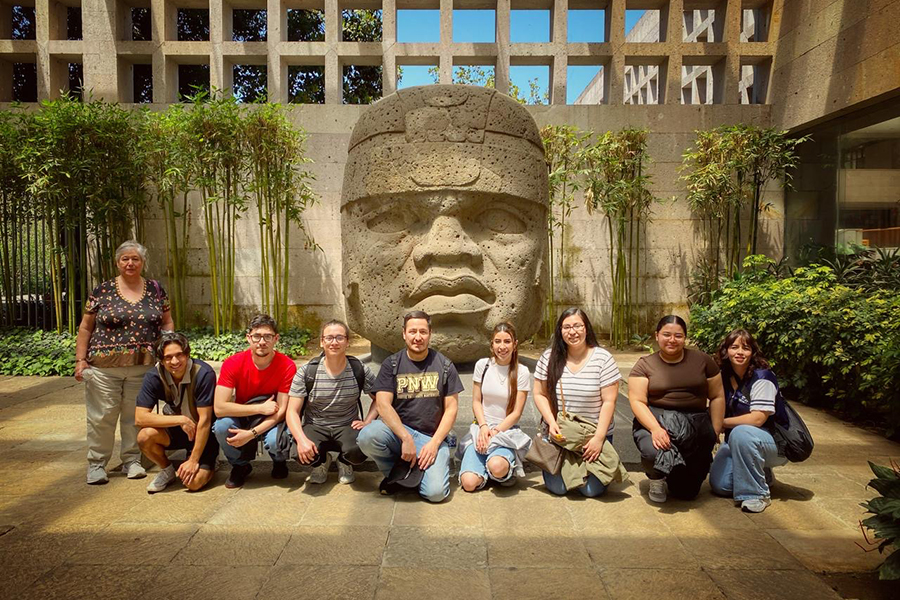 Study Away in Mexico - 9 students standing in front of a sculpture in Mexico