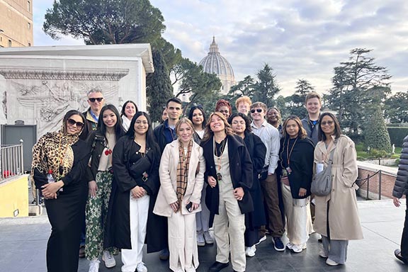 HTM students pose in front of famous structure in Italy for Study Away program