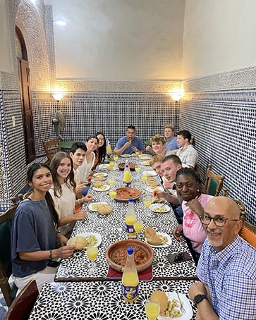 PNW students eating dinner with one another while in Morocco.
