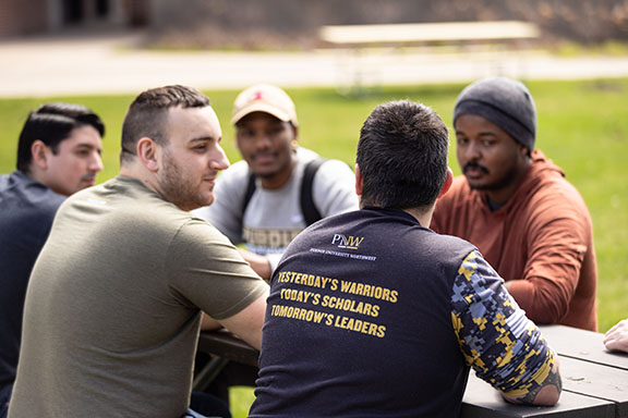 A group of veterans sit outdoors